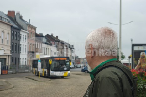 Oudere man wacht op de bus